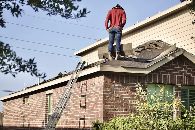 Professional roofer working on a residential roof in Marvin